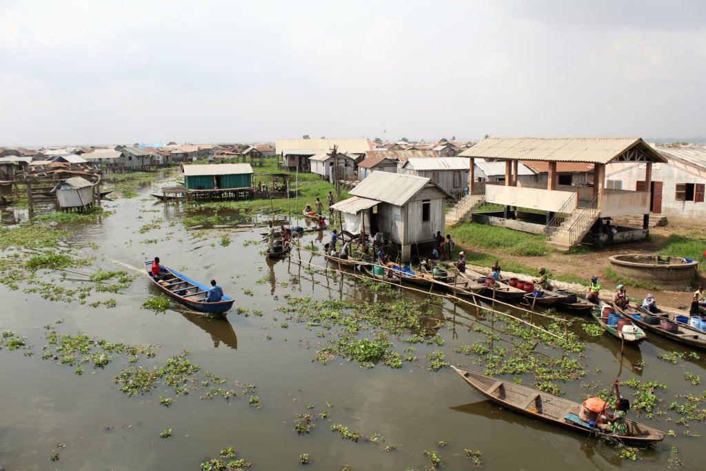 This photo shows a line of boats full of containers waiting to collect water