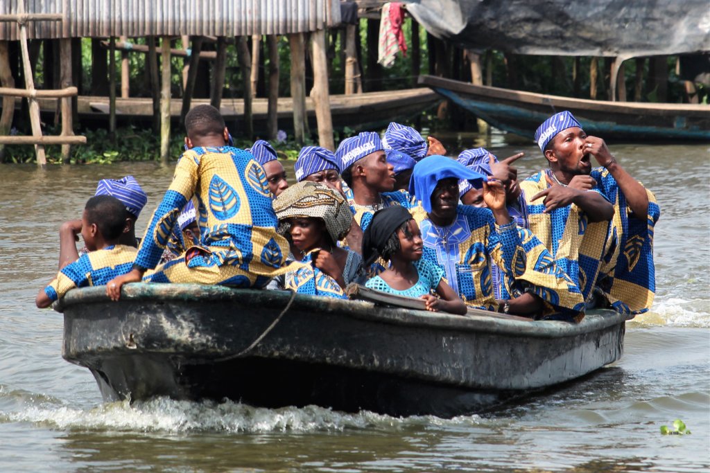 This photo shows a family group in their boat. They are all wearing outfits made from the same fabric.