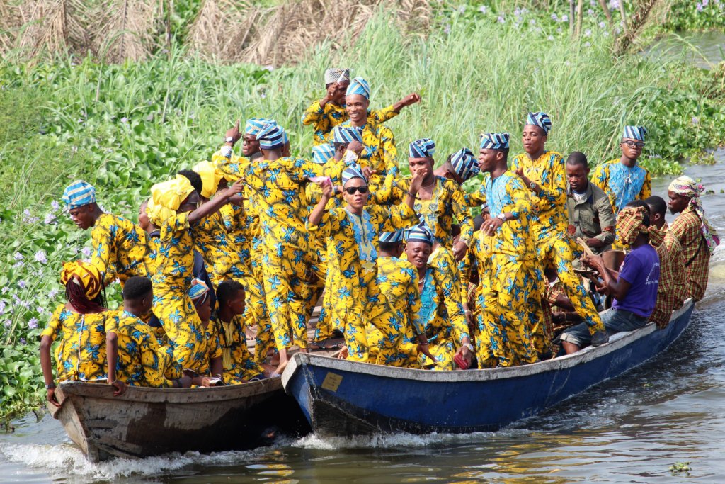 This photo shows two boats full of people all dressed in outfits made from the same fabric