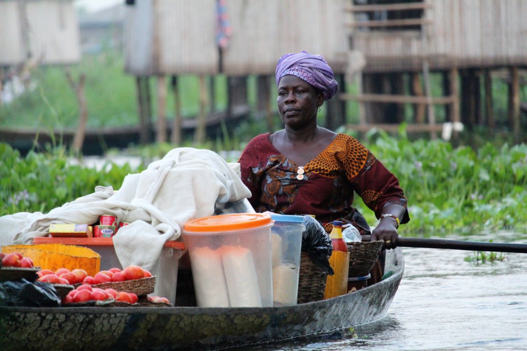 This photo shows a lady in her heavily-laden boat