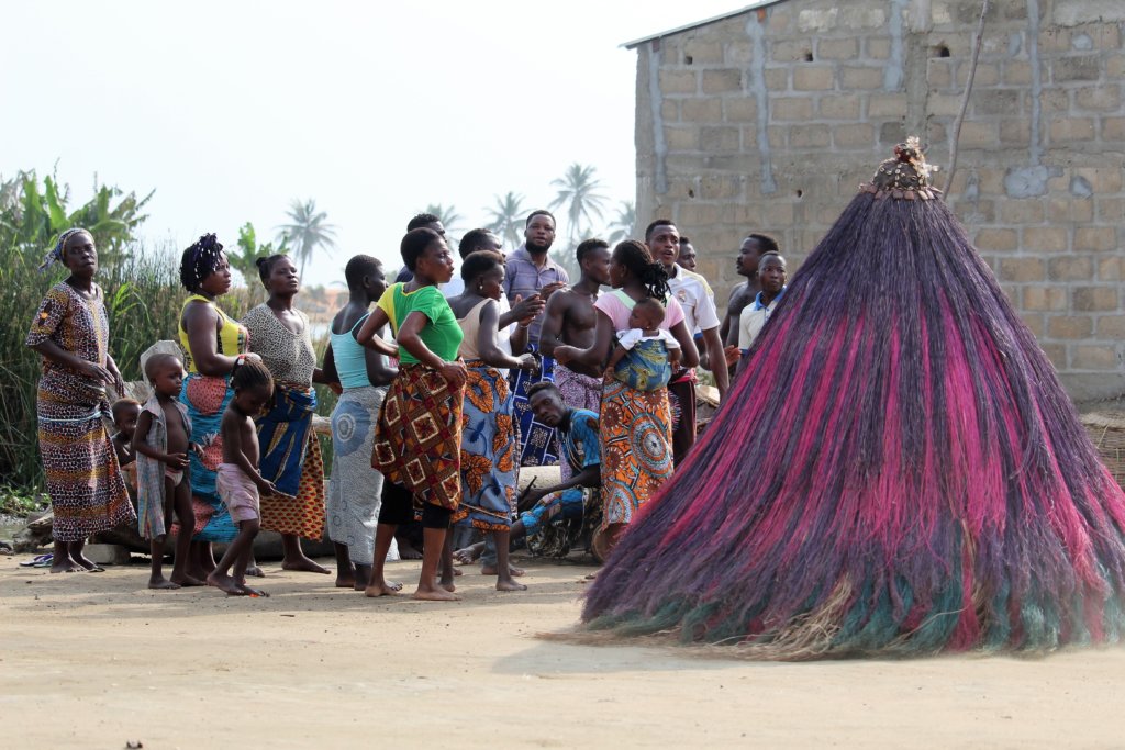 This photo shows a group of dancers and the pink Zangbeto