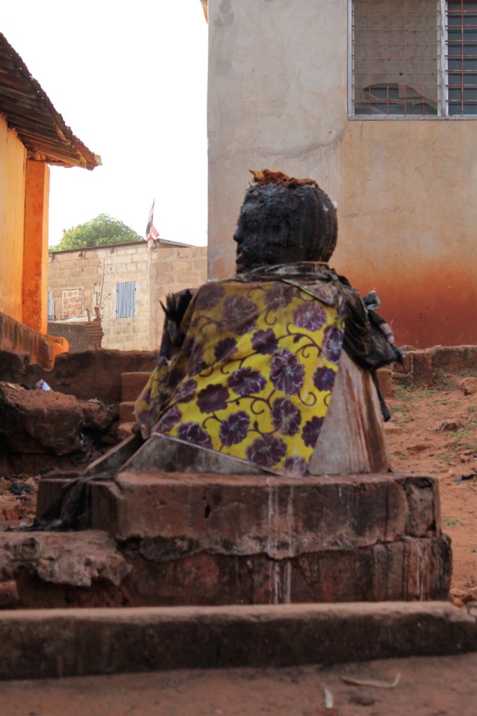 This photo shows a voodoo altar draped in patterned fabric