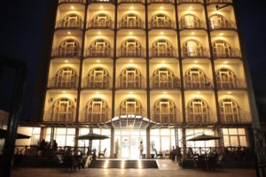 This photo shows the front of the Venetian Hotel Apartment illuminated at night