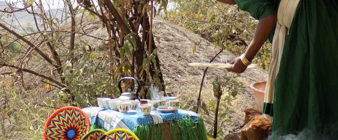 This photo shows a lady preparing coffee in the traditional way