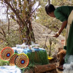 This photo shows a lady preparing coffee in the traditional way