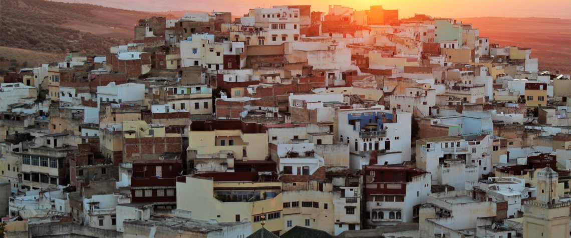 This photo shows the sun setting behind the holy city of Moulay Idris