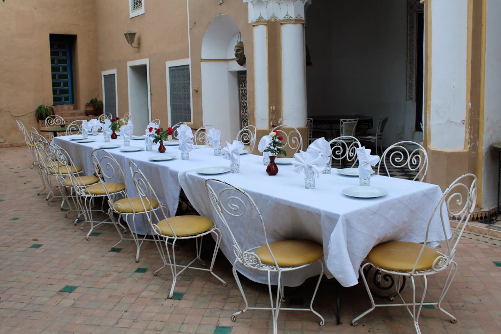 This photo shows our table laid for dinner with crisp white linen tablecloths and napkins