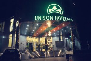 This photo shows the front of the Unison Hotel at night