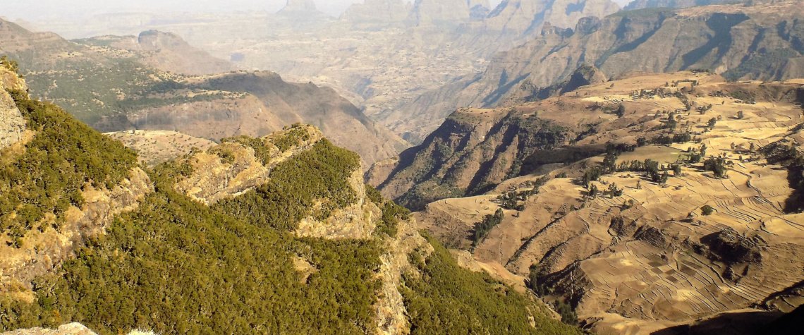 This photo shows rugged rocky scenery with spectacular mountains in the background