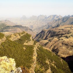 This photo shows rugged rocky scenery with spectacular mountains in the background