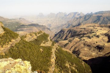 This photo shows rugged rocky scenery with spectacular mountains in the background