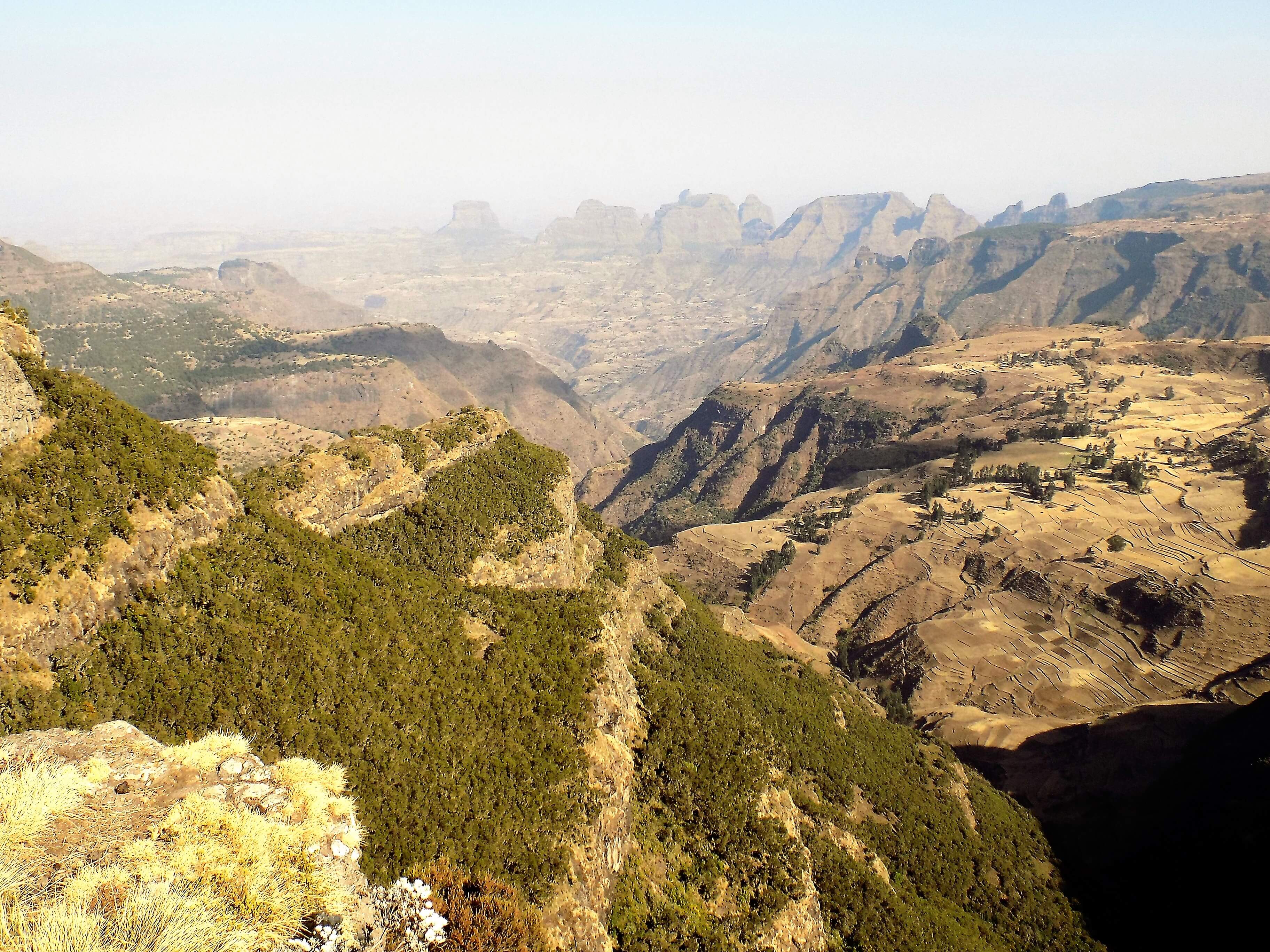 This photo shows rugged rocky scenery with spectacular mountains in the background