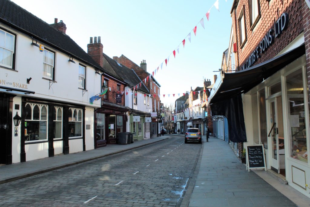 This photo shows Bailgate with attractive bunting hung across the street