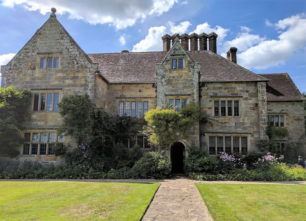 This photo shows the front of Bateman's with ivy growing up the walls