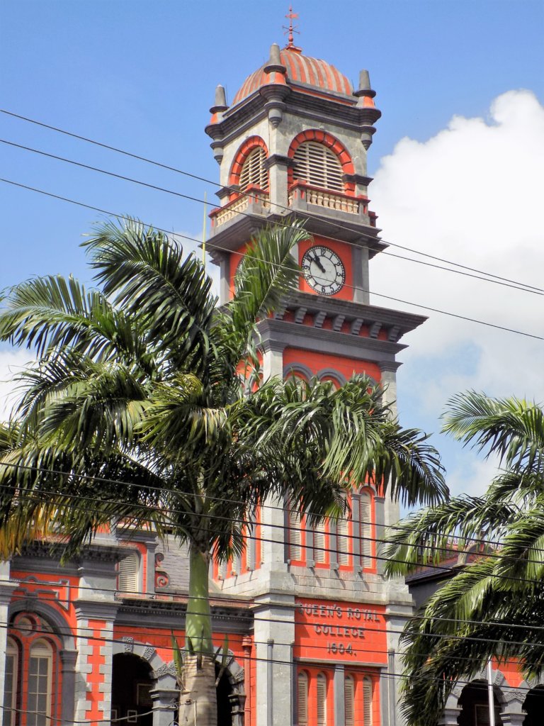 This photo shows the impressive orange and white facade of the Royal College complete with ornate clock tower