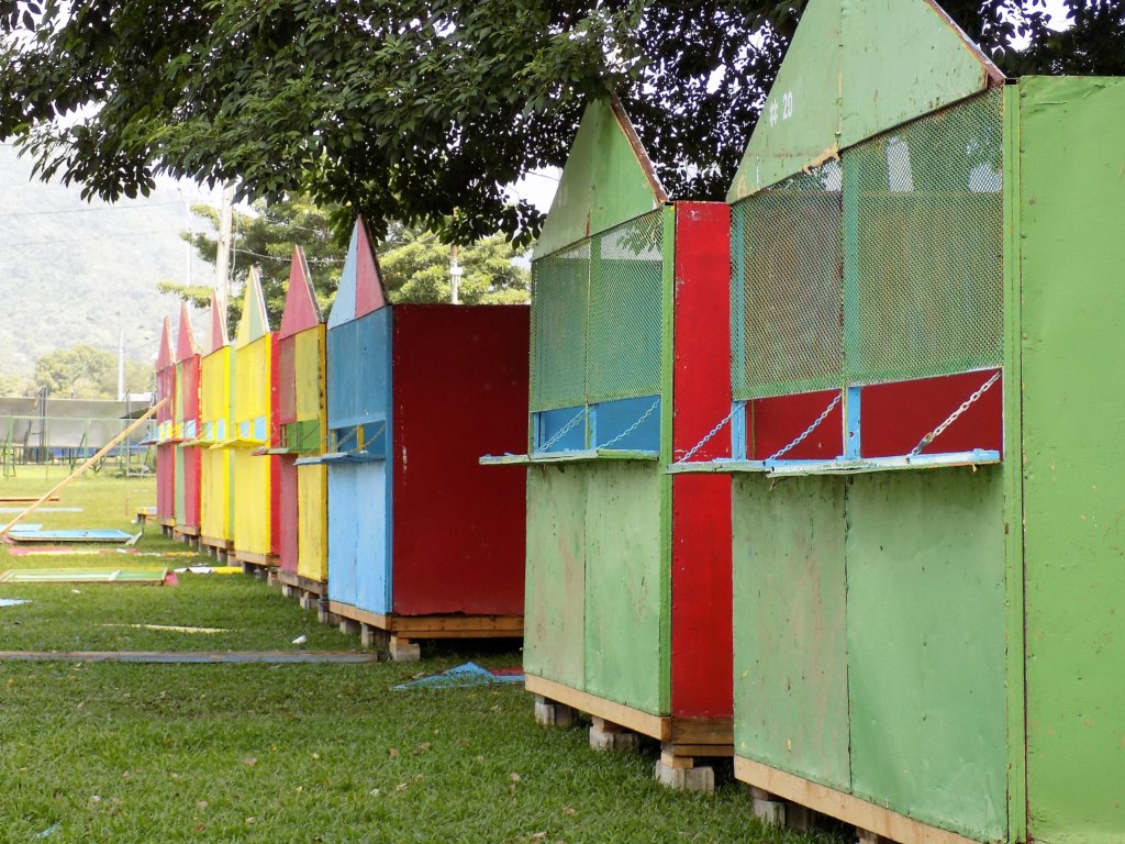 This photo shows colourful wooden huts erected on the edge of Queen's Park Savannah