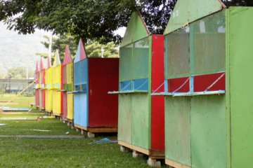 This photo shows colourful wooden huts erected on the edge of Queen's Park Savannah