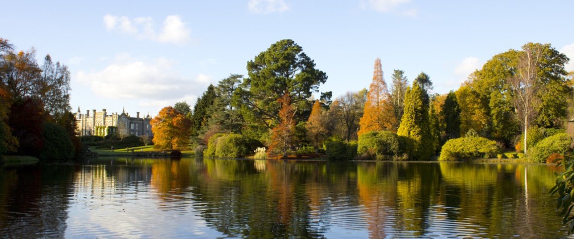 This photo shows one of the lakes in Sheffield Park with Sheffield Park House in the background