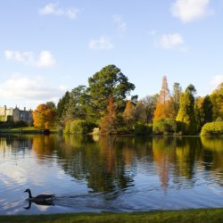 This photo shows one of the lakes in Sheffield Park with Sheffield Park House in the background