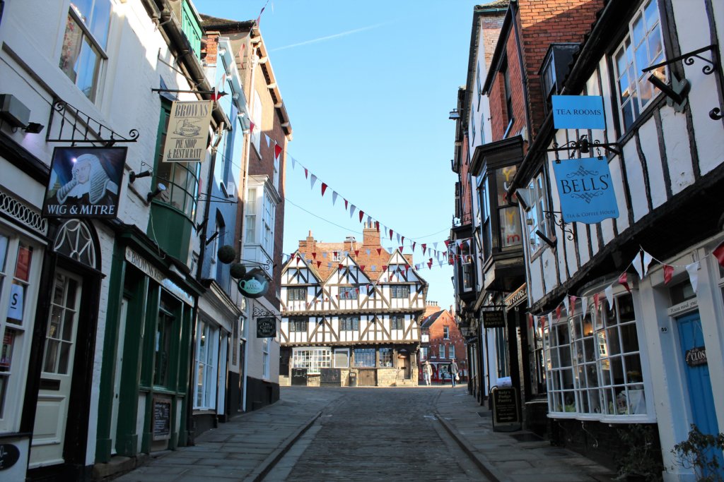 This photo shows Steep Hill with the Tudor timbered tourist office at the top.