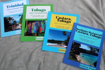 This photo shows four colouring books featuring images of the Caribbean