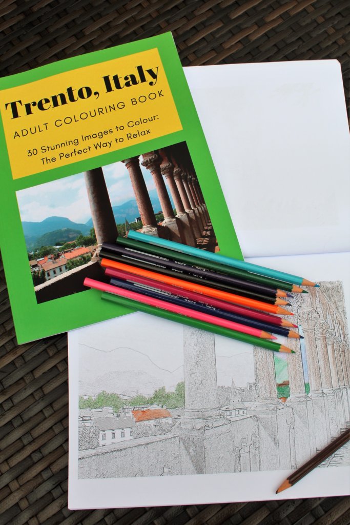 This photo shows my Trento colouring book and a half-completed image from the book with some coloured pecils on top of it.