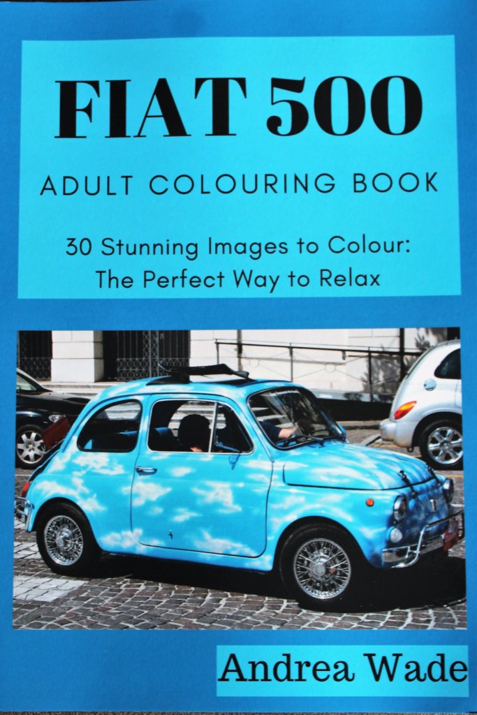 This photo shows the front cover of my Fiat 500 colouring book with an image of a car painted sky blue with fluffy white clouds