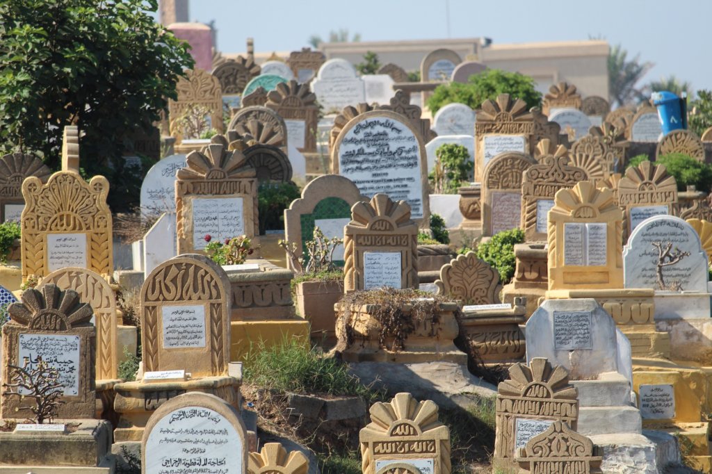 This photo shows a number of headstones crowded together with inscriptions in Arabic