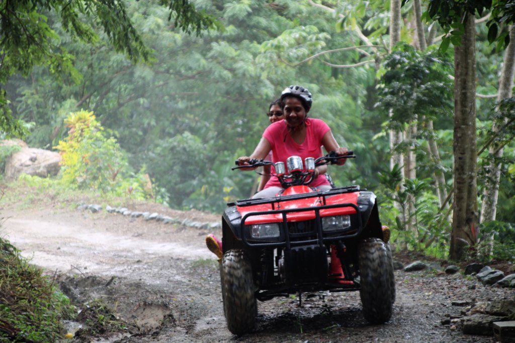 This photo shows a girl riding a quad bike up the nature trail at Concordia Estate