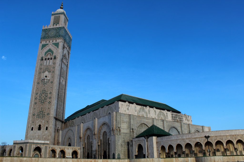 This photo shows Hassan II Mosque set against a brilliant blue cloudless sky