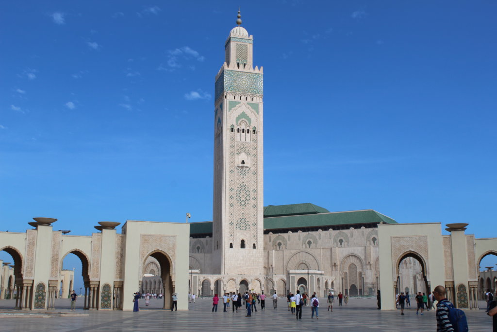 This photo shows the white minaret of Hassan II Mosque set against a brilliant blue cloudless sky 