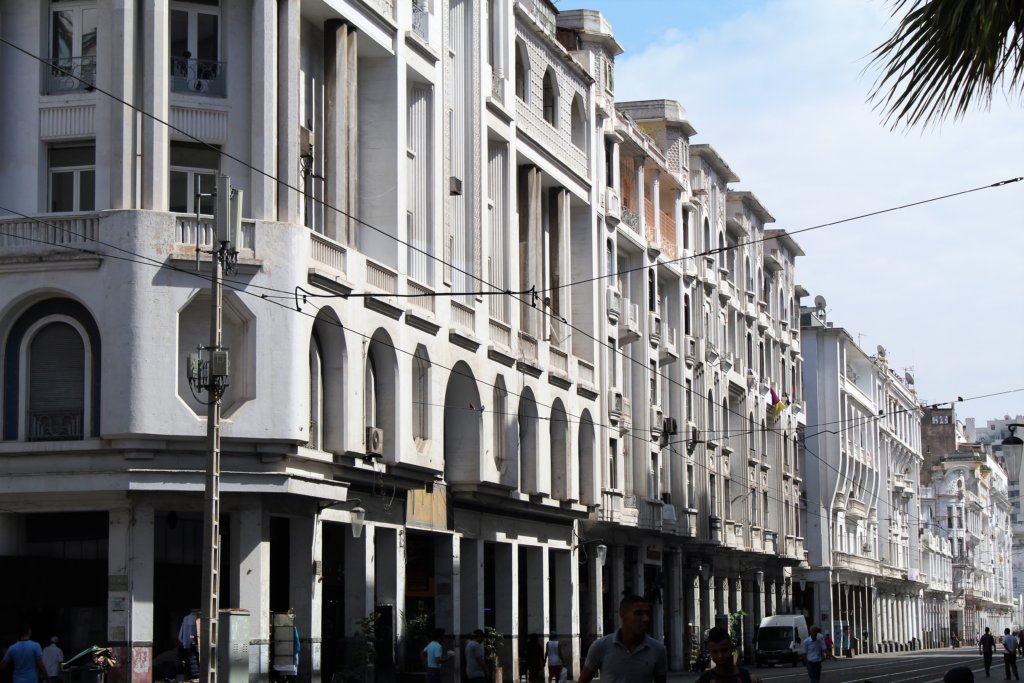 This photo shows a row of white buildings in the mauresque style