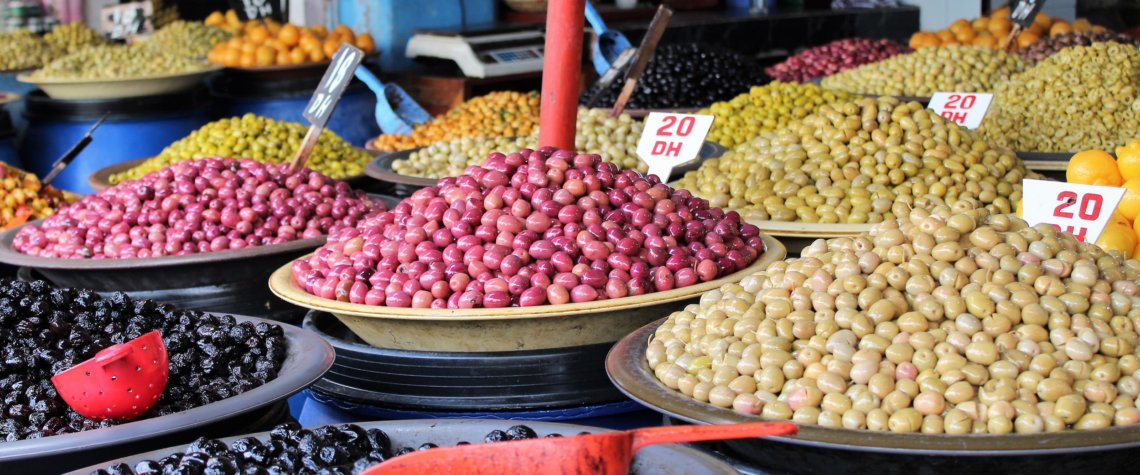 This photo shows bowls of colourful olives on sale