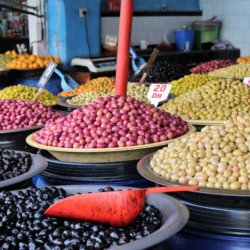 This photo shows bowls of colourful olives on sale