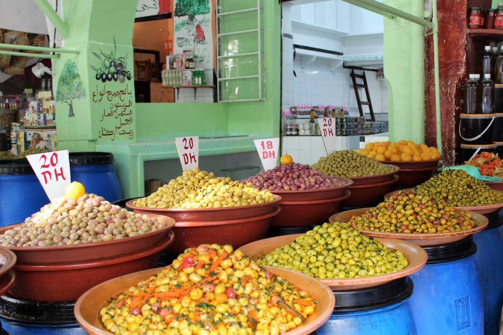 This photo shows bowls of different varieties of olive for sale in the wholesale olive market