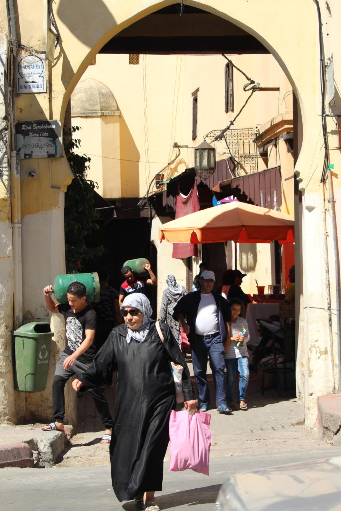 This photo shows an alleyway in Meknes souk busy with people going about their business