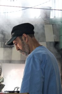 This photo shows our chef with the smoke of other barbecues all around him