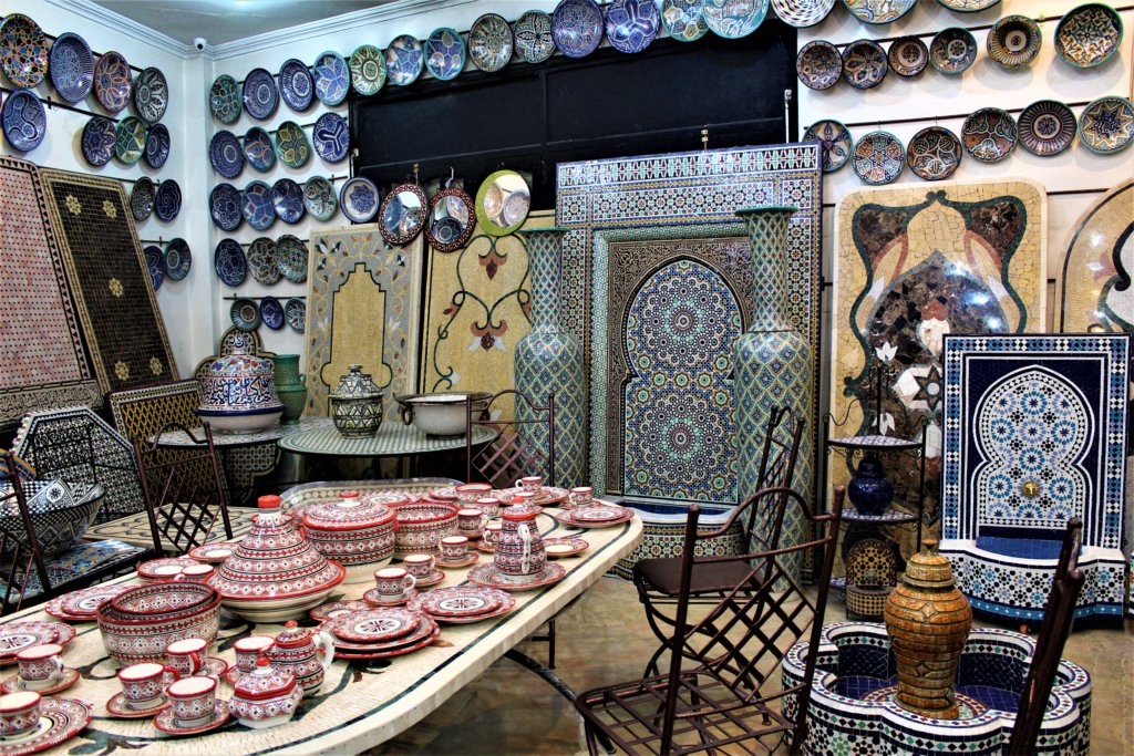 This photo shows the showroom at the pottery with lots of plates, mosaic items, and a dinner service