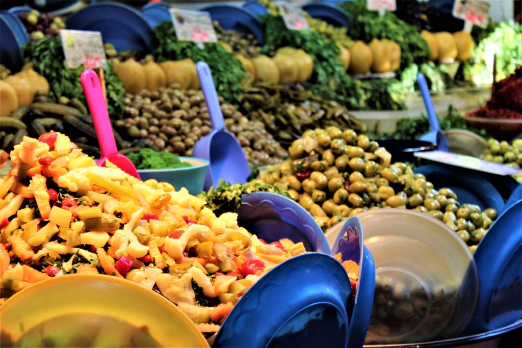 This photo shows a colourful display of olives for sale in the medina