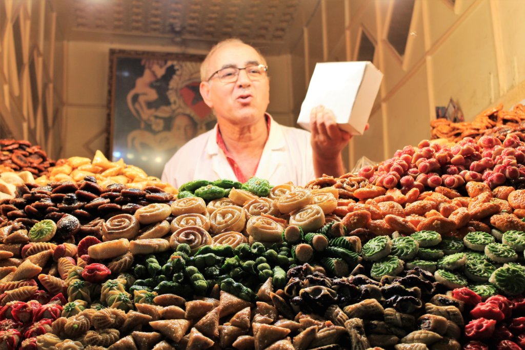 This photo shows the cookie seller behind his amazing display of colourful cookies