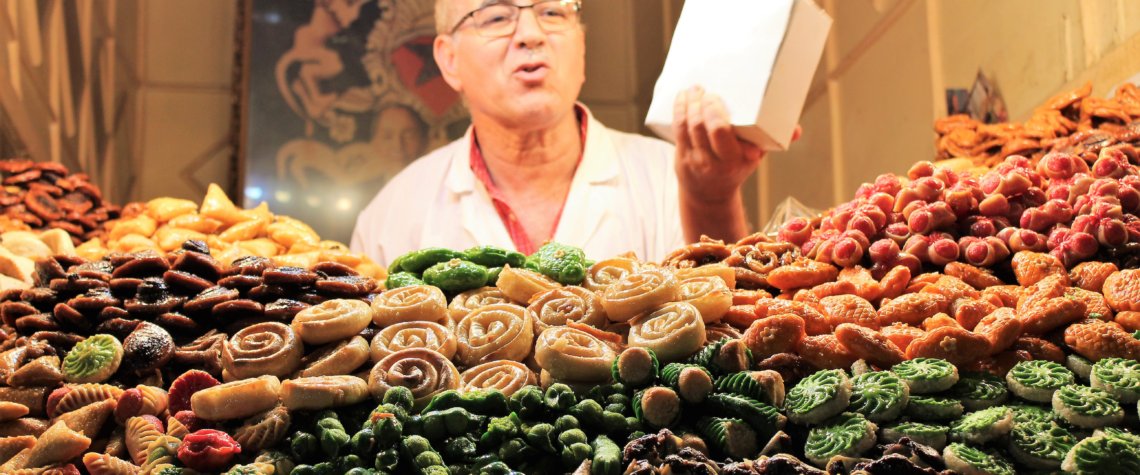 This photo shows the cookie seller behind his amazing display of colourful cookies