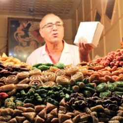 This photo shows the cookie seller behind his amazing display of colourful cookies