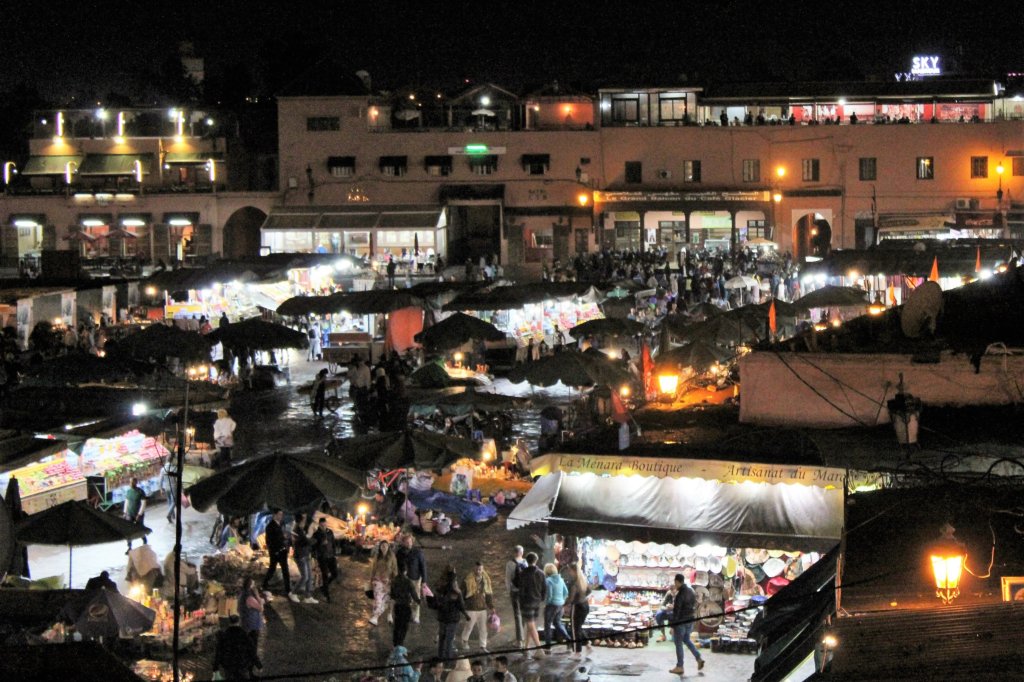 This photo shows Djemaa el-Fna at night - full of food stalls and packed with people