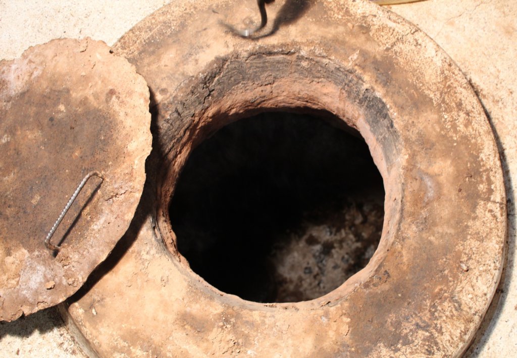 This photo shows the clay pit sunk below floor level where the whole sheep are roasted