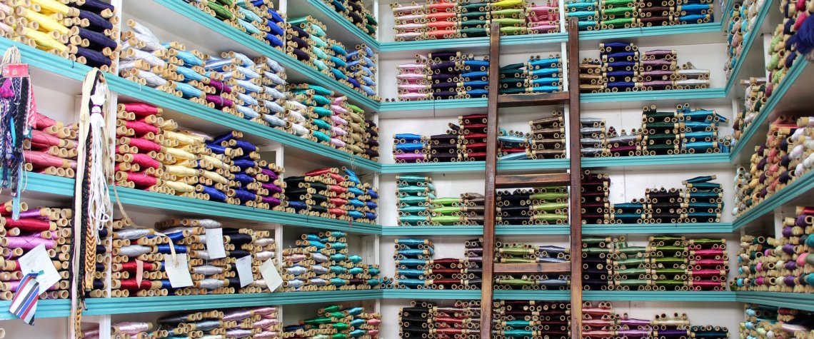 This photo shows shelves full of coloured silk threads