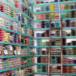 This photo shows shelves full of coloured silk threads