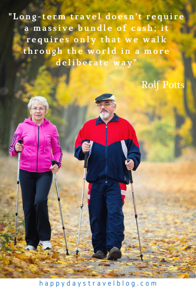 This photo shows an older couple walking through the woods with the quote by Ralf potts, 'Long-term travel doesn't require a massive bundle of cash; it only requires that we walk through the world in a more deliberate way.'