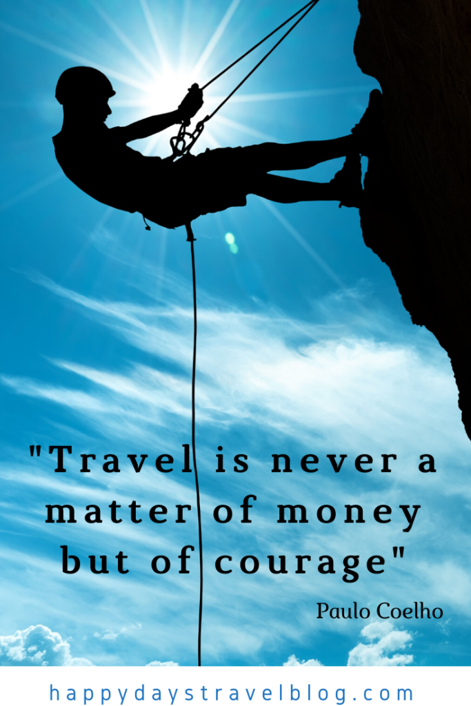 This photo shows the silhouette of a man abseiling down a cliff with the quote by Paulo Coelho superimposed, 'Travel is never a matter of money but of courage.'