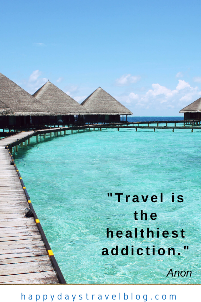 This photo shows a wooden walkway and bungalows sited over a turquoise sea with the quote, 'Travel is the healthiest addiction.'