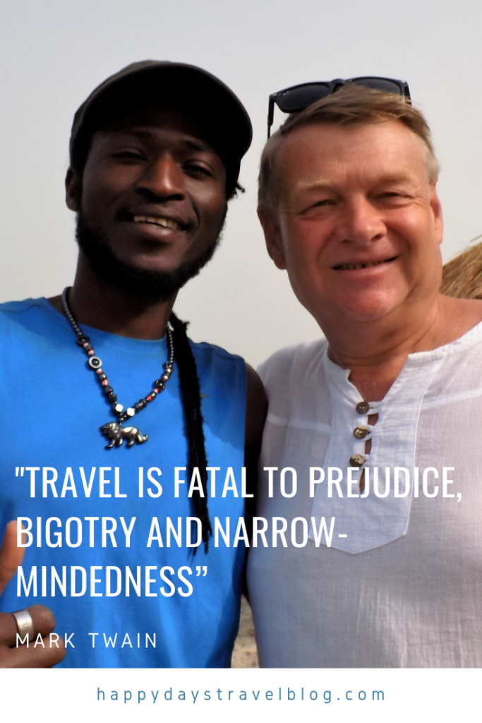 This photo shows a black man and a white man with the quote 'Travel is fatal to prejudice, bigotry and narrow-mindedness' by Mark Twain